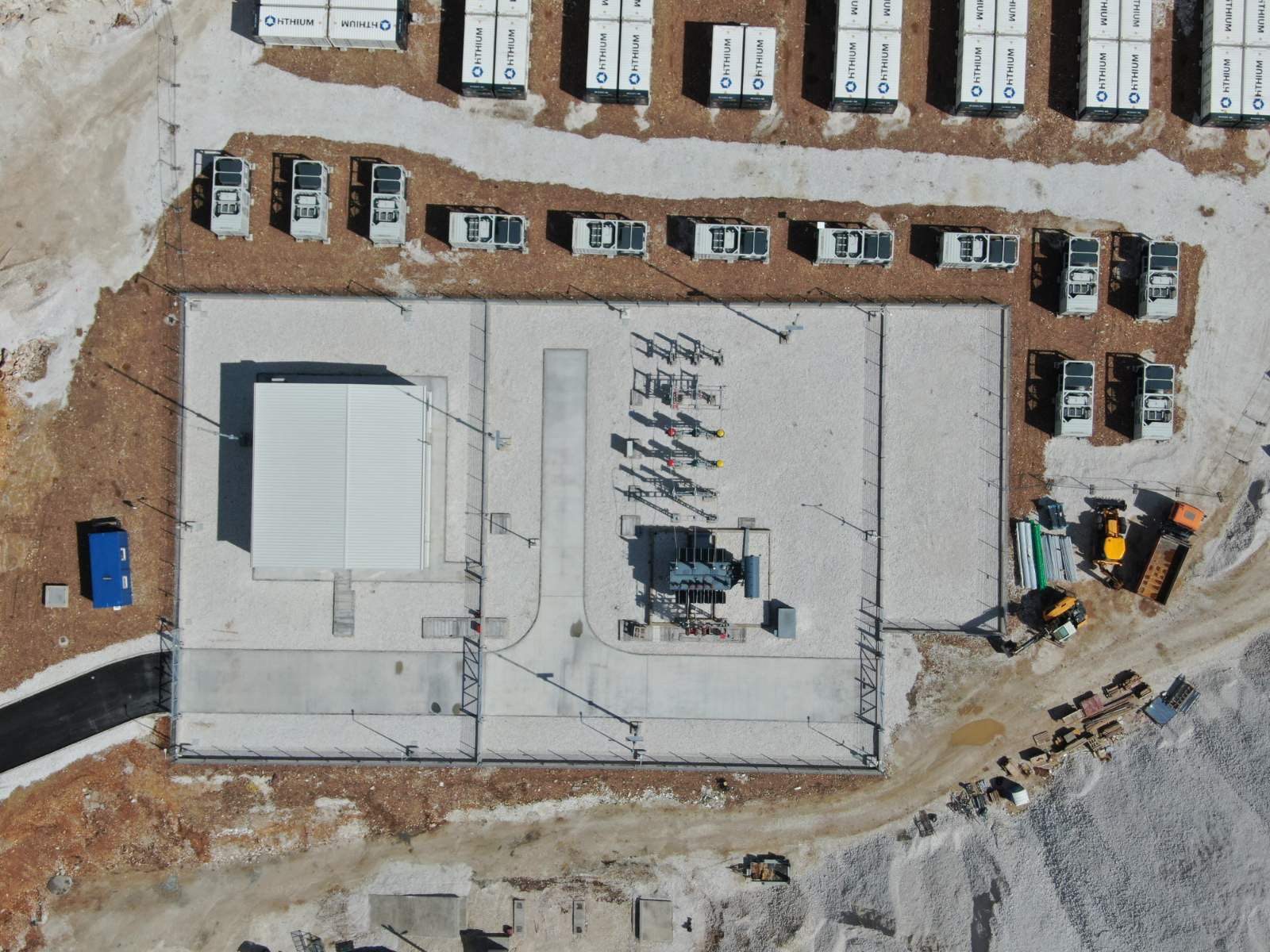 Top-down view of the completed Project Jupiter substation and control building — transformer, switchgear, and adjacent rows of Hithium battery containers.